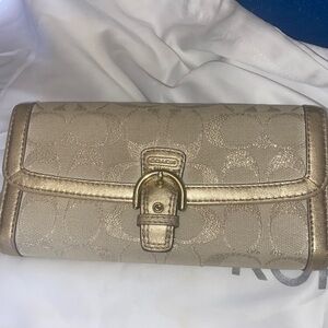 Coach authentic, gold color, tan inside, has some scuffs inside.